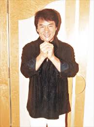 This picture shows Hong Kong superstar Jackie Chan saying thank you to his fans in Chinese, demonstrating a characteristic Chinese handshake motion, useful if you translate thank you to Chinese.